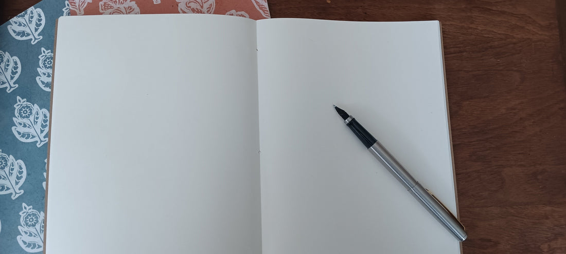 A notebook and pen for tracking how you feel/