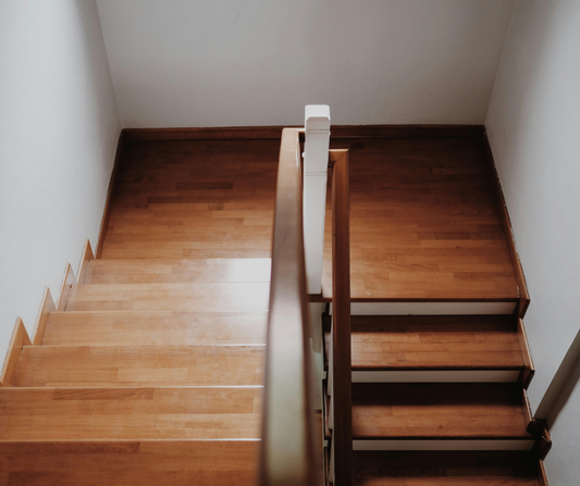 A view lookinng down on wooden stairs and a landing.